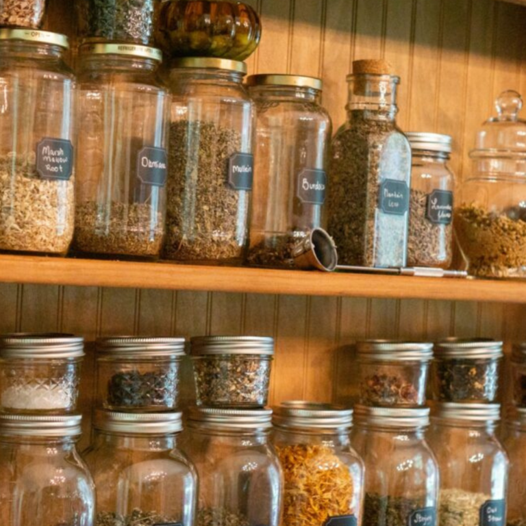 home apothecary shelf full of herbs